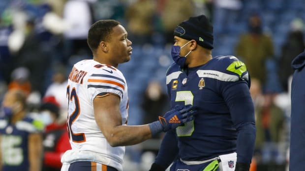 Dec 26, 2021; Seattle, Washington, USA; Chicago Bears running back David Montgomery (32) talks with Seattle Seahawks quarterback Russell Wilson (3) following a 25-24 Chicago victory at Lumen Field. Mandatory Credit: Joe Nicholson-USA TODAY Sports